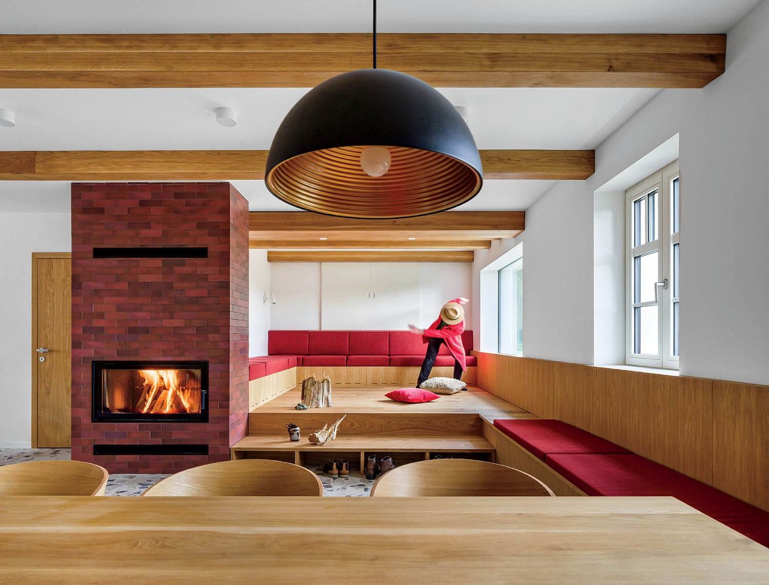 A woman sitting on a bench in a living room.