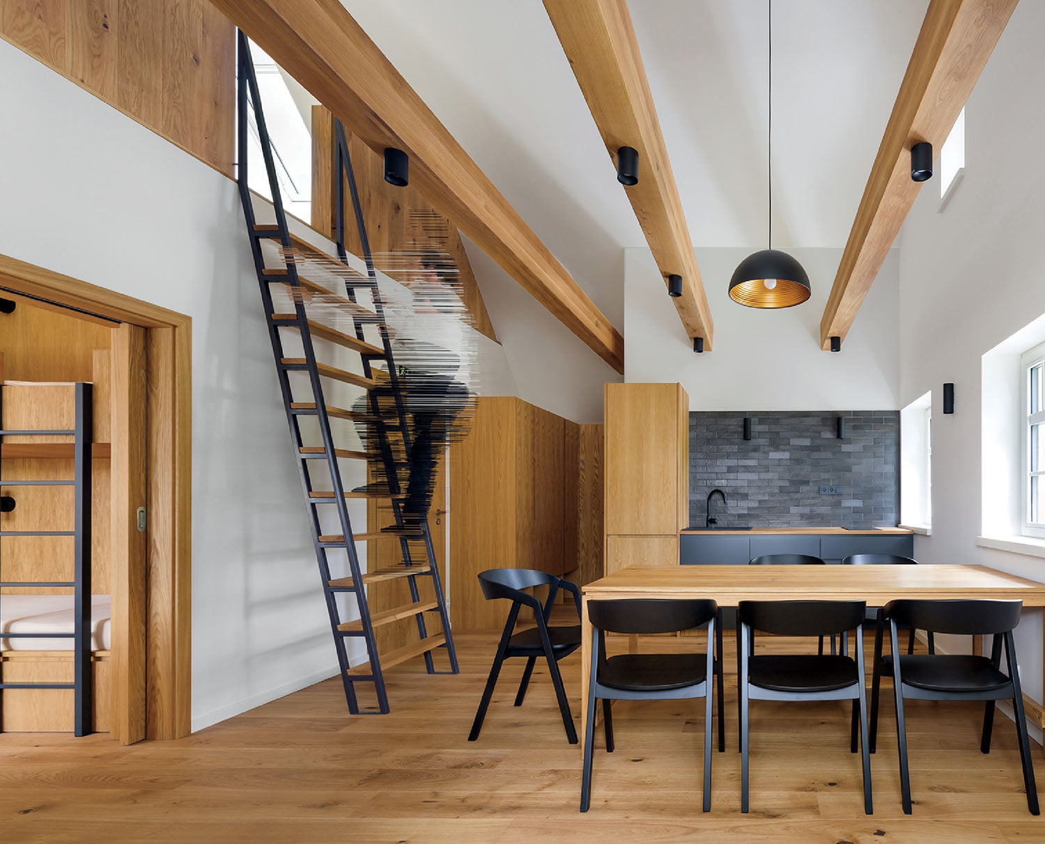 A dining table and chairs in a room.