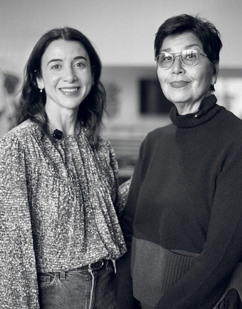 Two women standing next to each other women