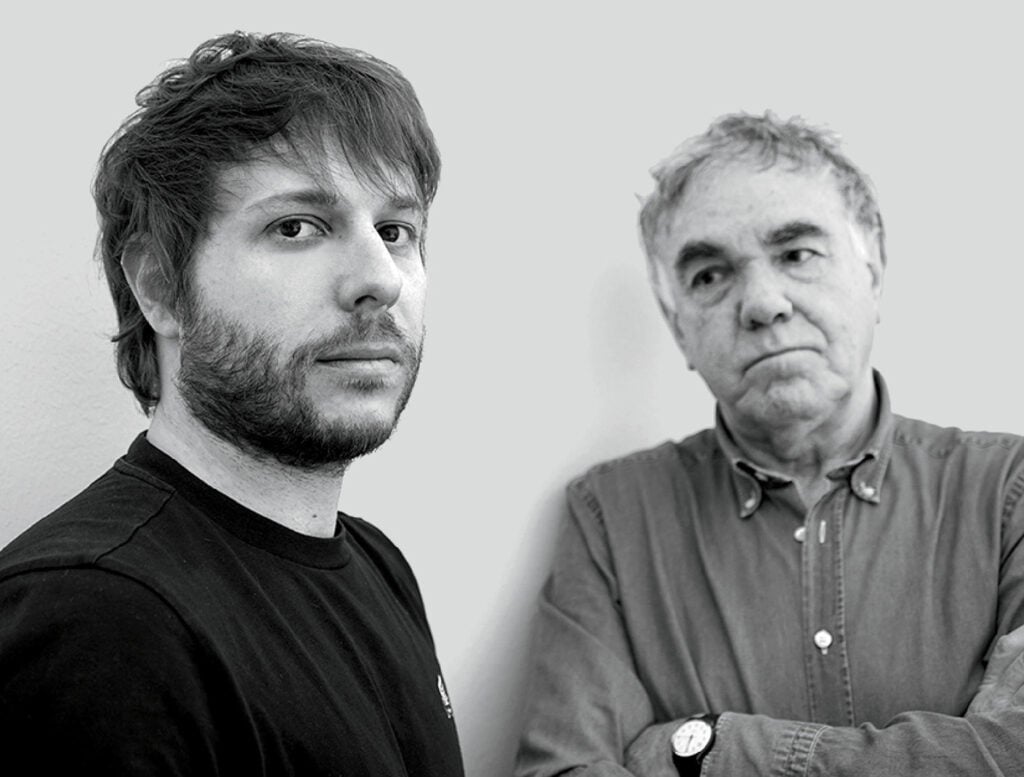 Two men standing next to each other man