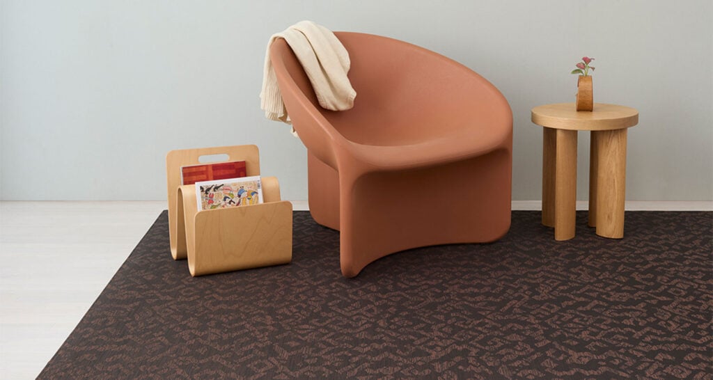 peach colored chair with magazine rack