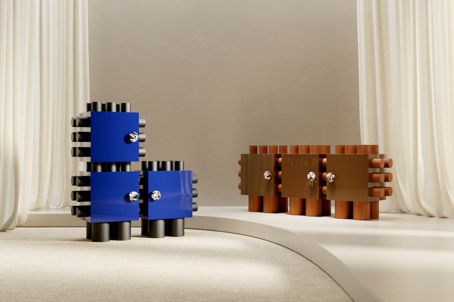 Two sets of modern, blocky cabinets in blue and brown, with cylindrical legs and silver knobs, are displayed on a light, curved platform against cream-colored curtains.
