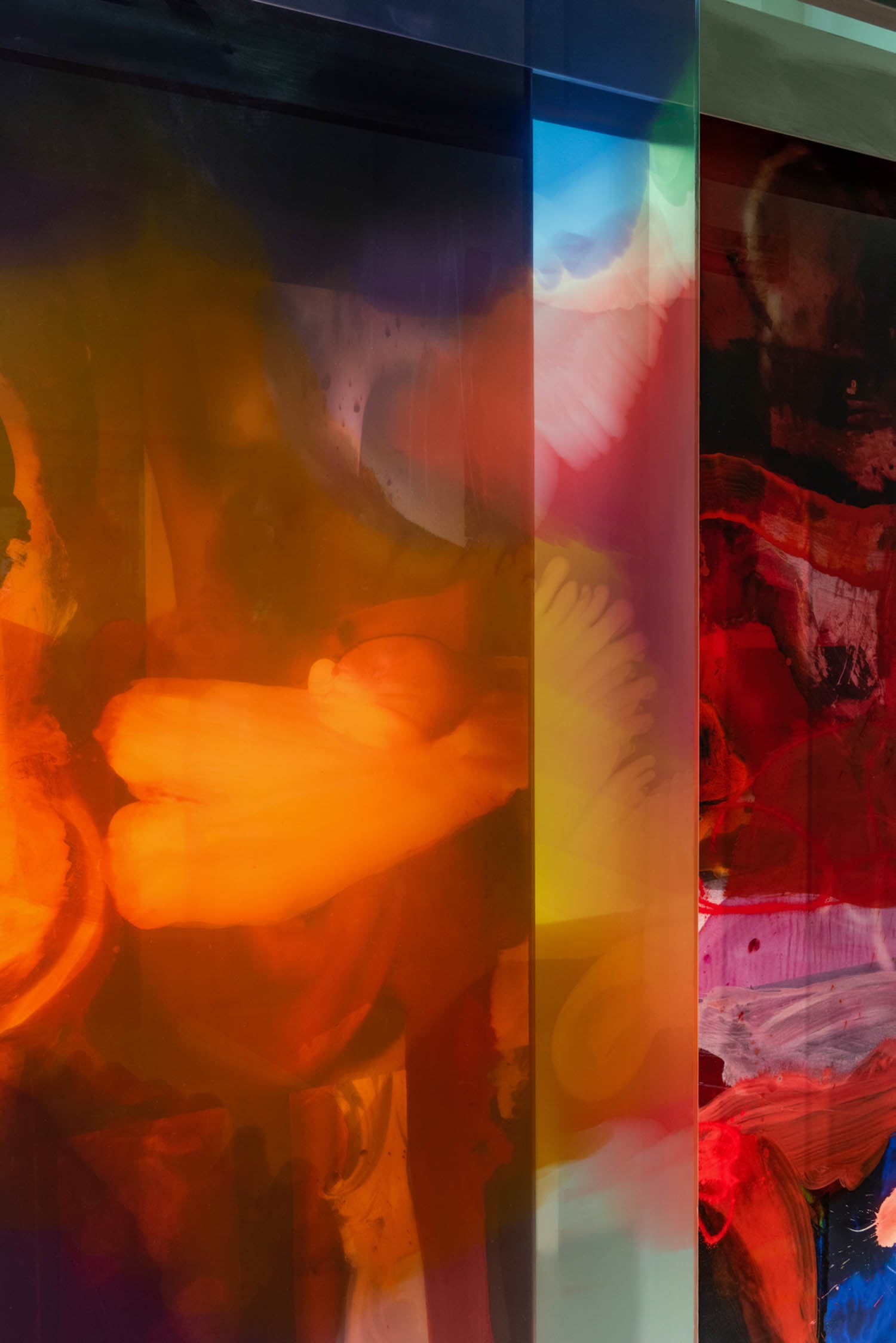 Abstract artwork featuring vibrant swirls and blocks of orange, red, yellow, and blue colors with layered translucent effects.