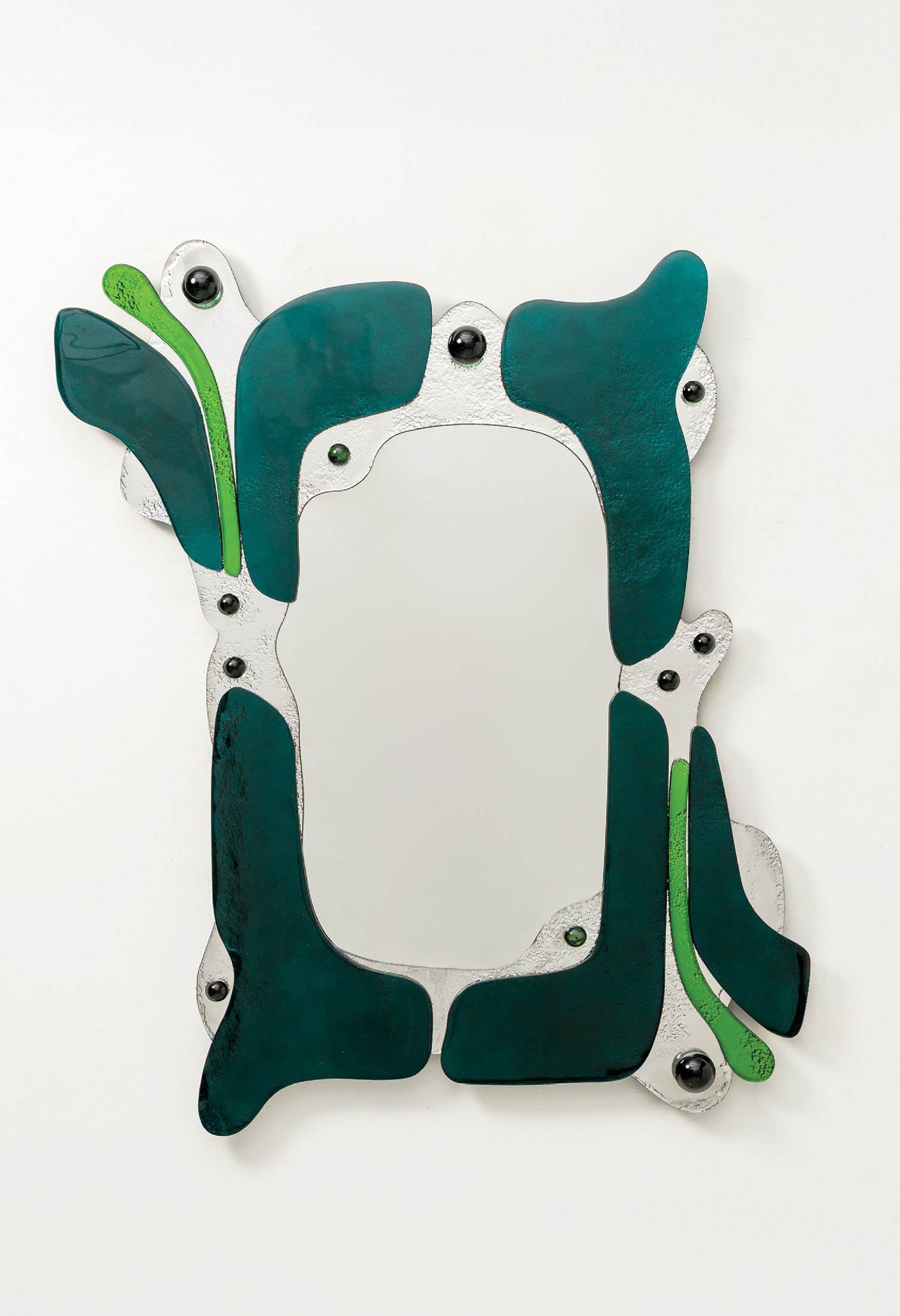 A rectangular mirror with an abstract silver frame featuring green and teal organic shapes and black circular accents on a white background.