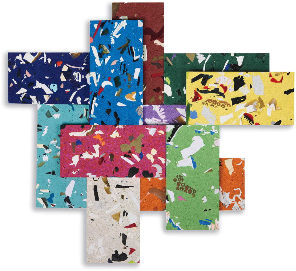 Rectangular tiles in various colors and abstract terrazzo patterns are arranged in an overlapping, cross-like formation on a white background.