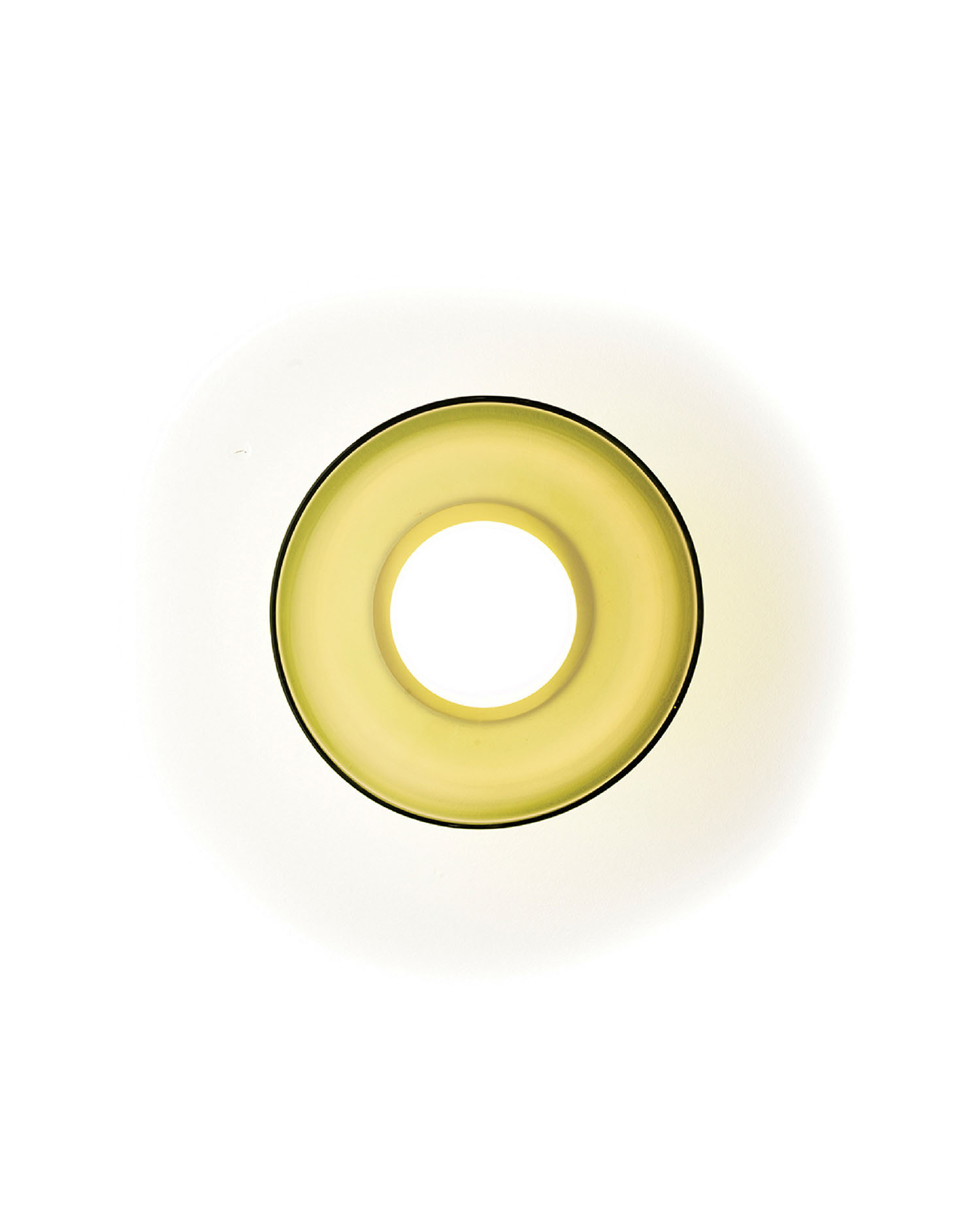 A yellow, translucent, circular object with a hollow center is shown against a white background, resembling a ring or donut shape.