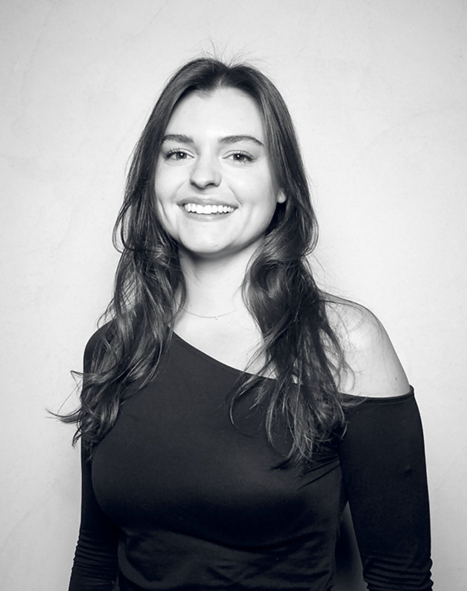 A woman in a black shirt smiling.