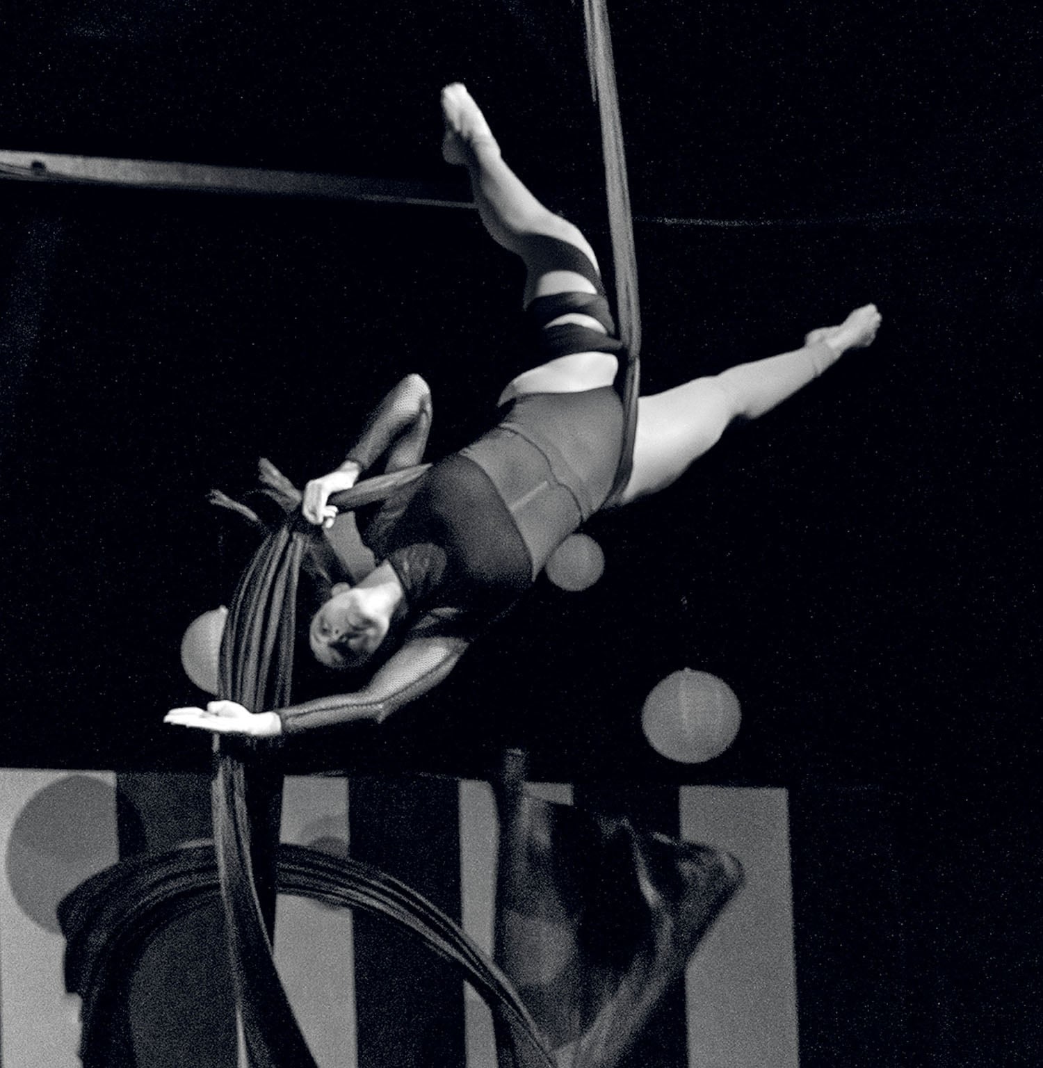 A woman in a tight suit is doing a trick.
