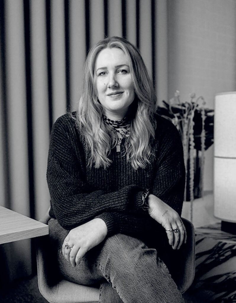 A woman sitting on a chair.