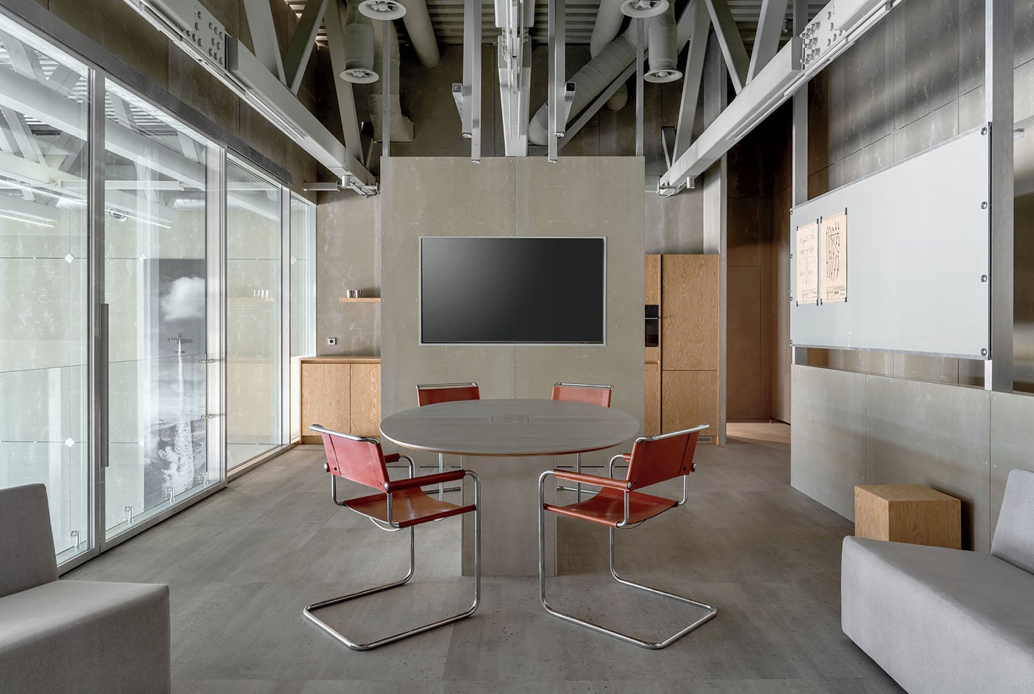 A room with a table, chairs, and a television.
