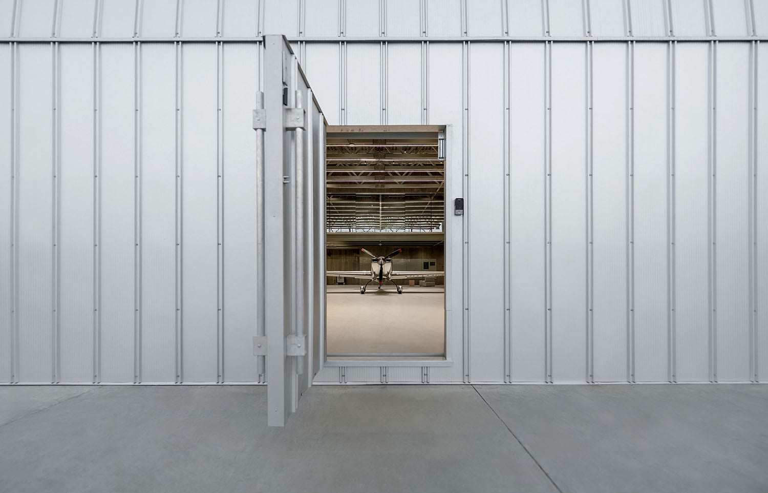 A white building with a large open door.