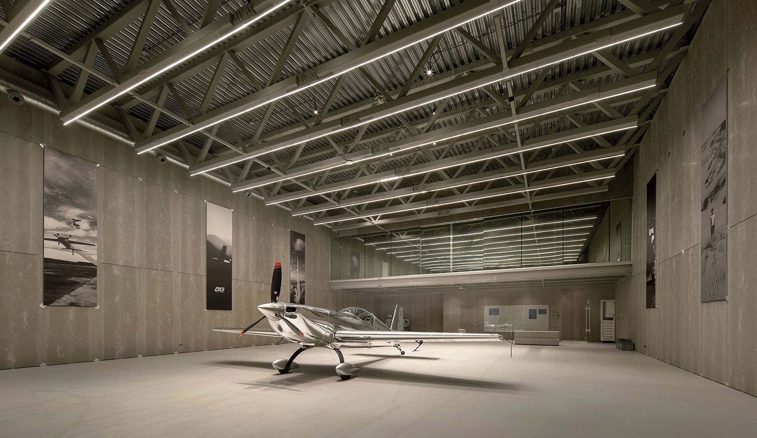 A small plane is parked in a large room.