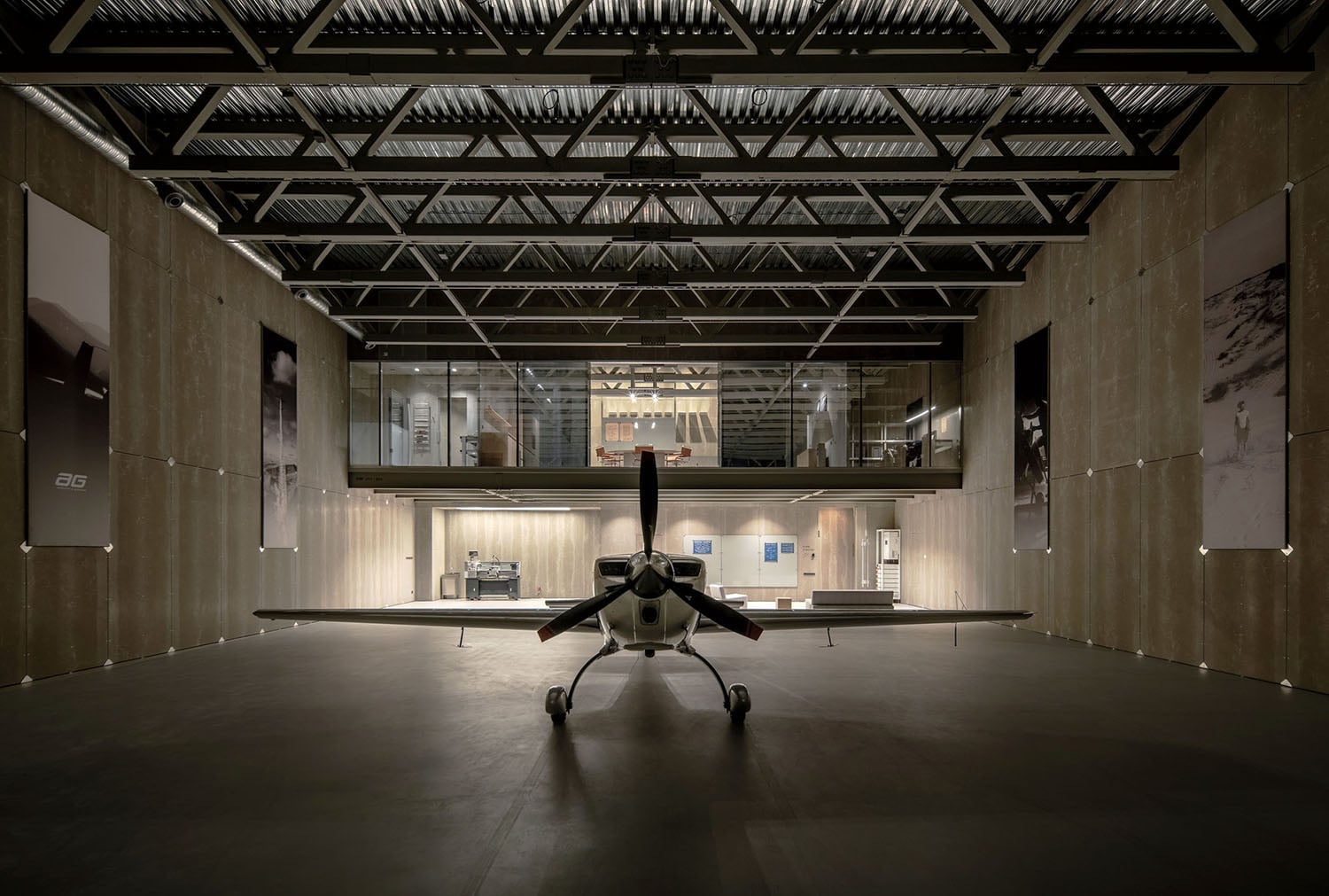A small plane is in a large room.