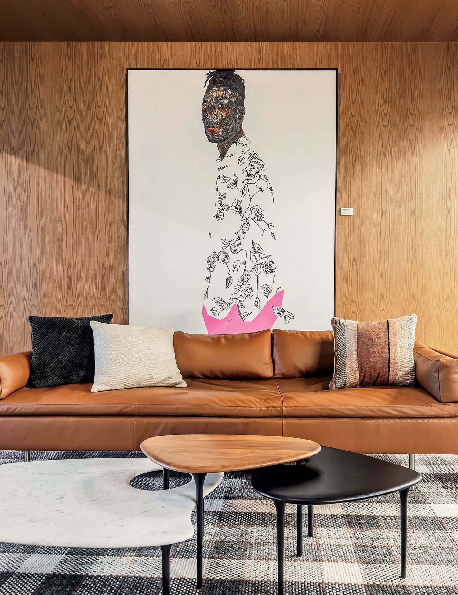 A living room with a couch, coffee table and a painting.