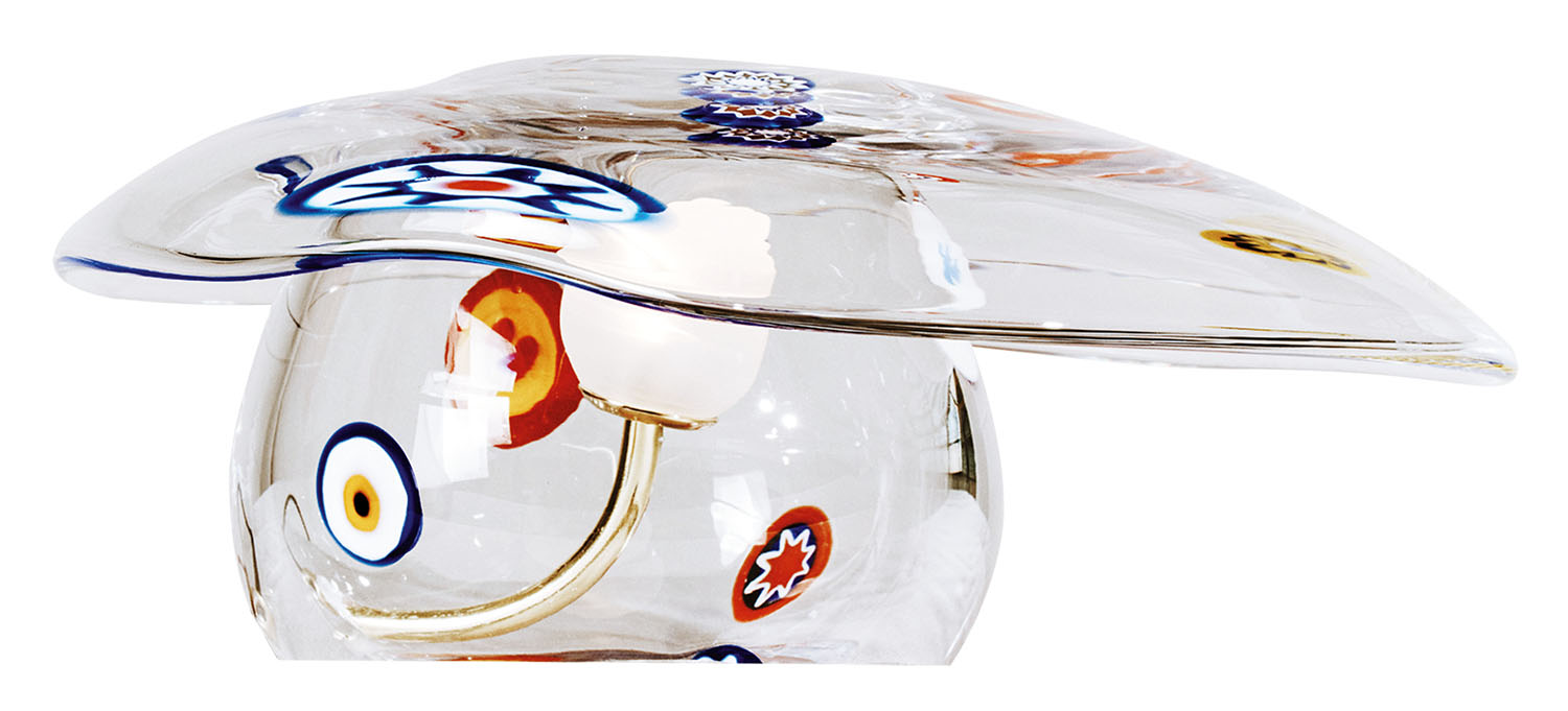 A clear glass mushroom-shaped lamp with colorful circular and star patterns on both the shade and base.