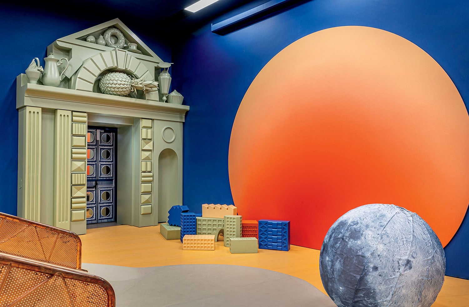 A room with a clock, a chair, and a table.
