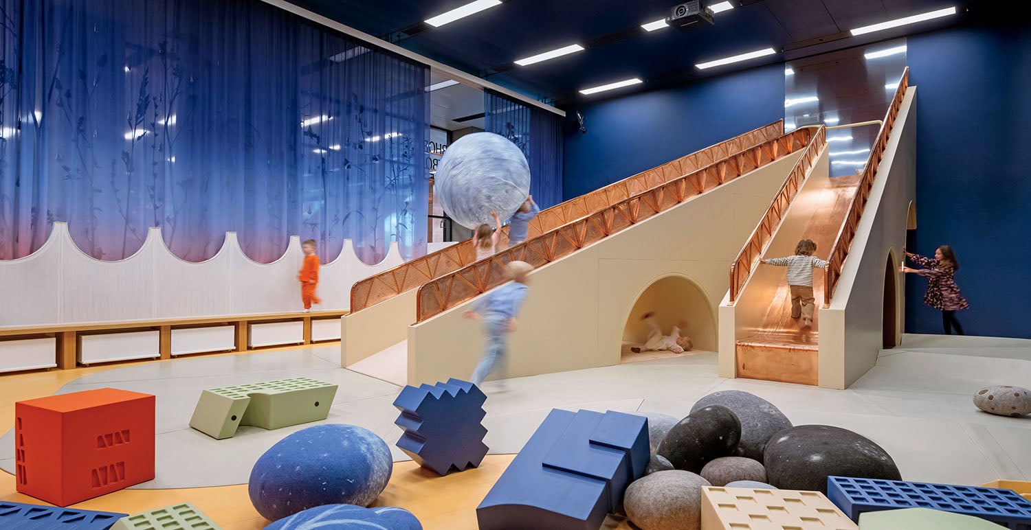 A room with a staircase and a large sculpture.