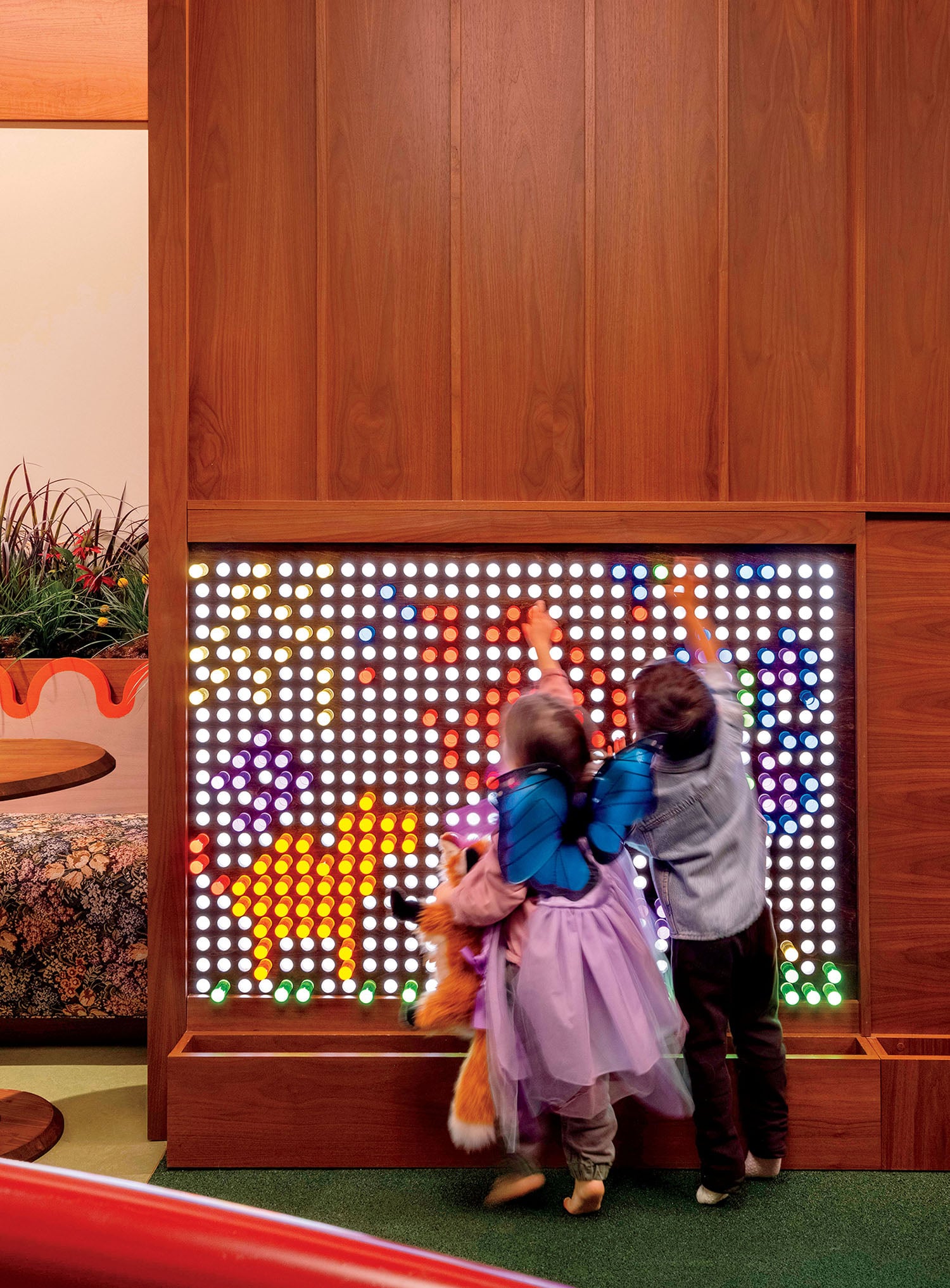 A couple of children playing in a room.