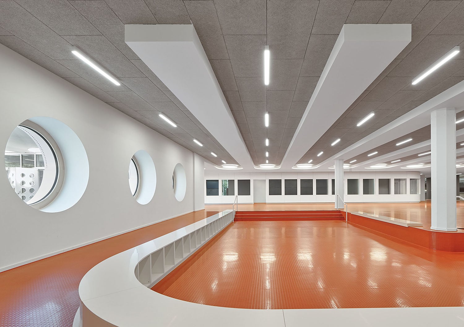 A large room with a red floor and white walls.