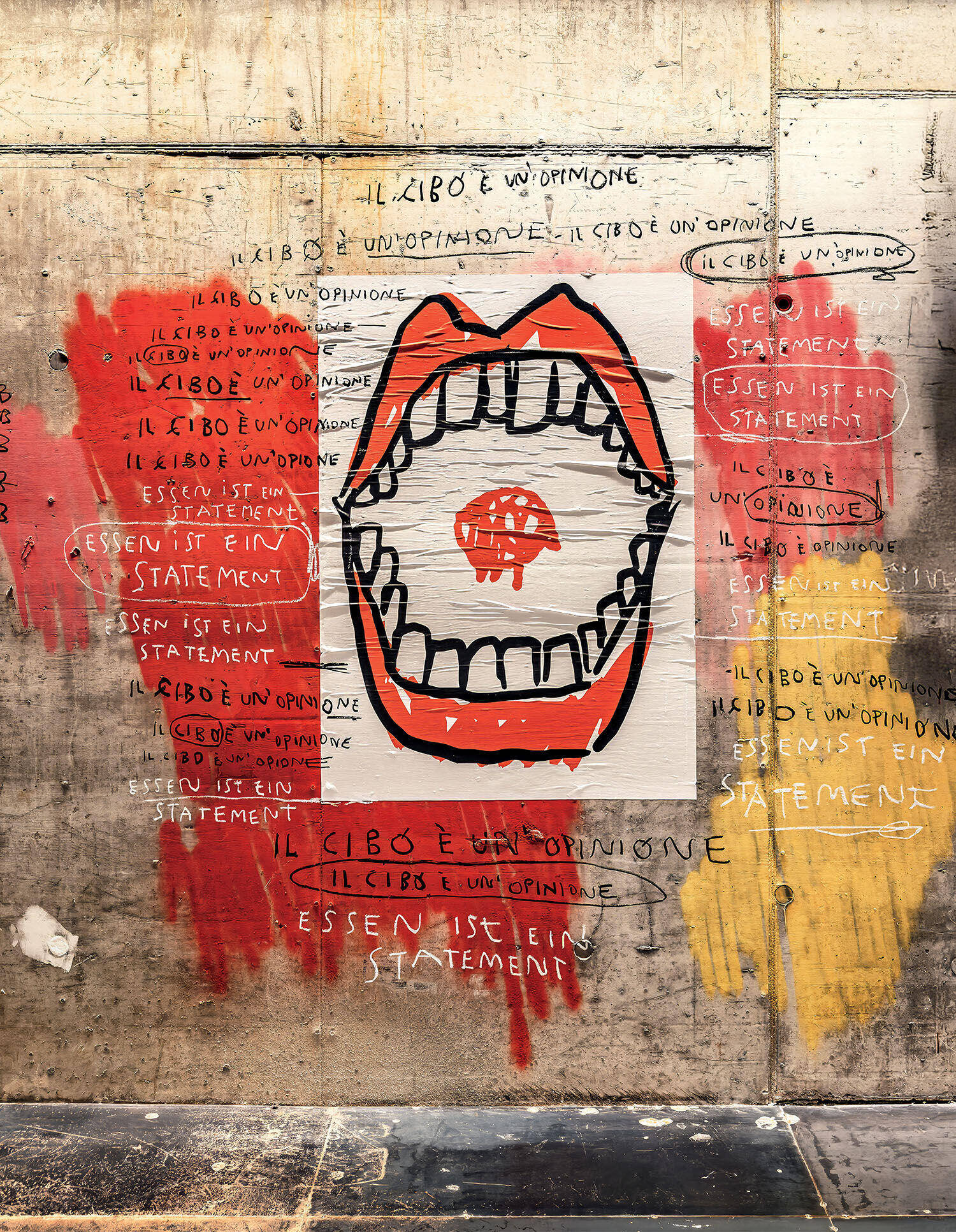 A mural on a concrete wall features a large open mouth with a mushroom inside, surrounded by phrases in various languages stating, "Food is an opinion. Food is a statement.