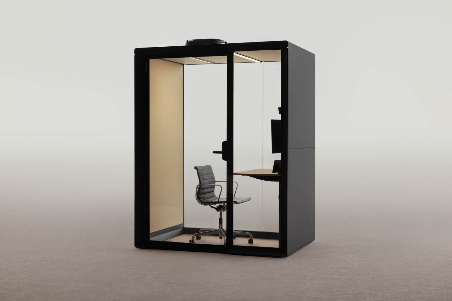 A modern Framery glass-walled office pod with a swivel chair, built-in desk, and monitor inside, set against a plain, neutral background.