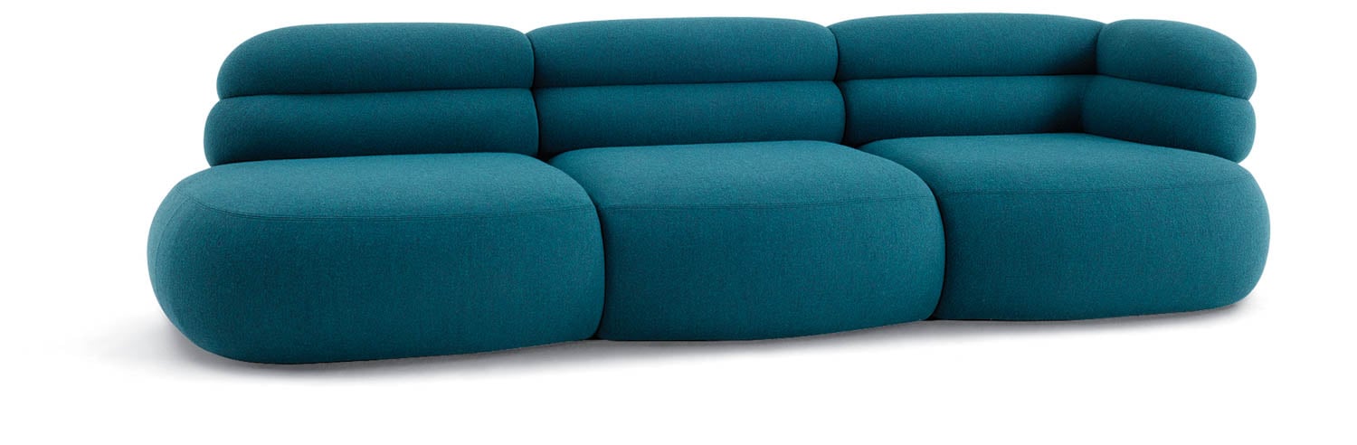 A modern teal upholstered sofa with rounded edges and three seat sections, featuring a low, padded backrest and armrest on the right side.