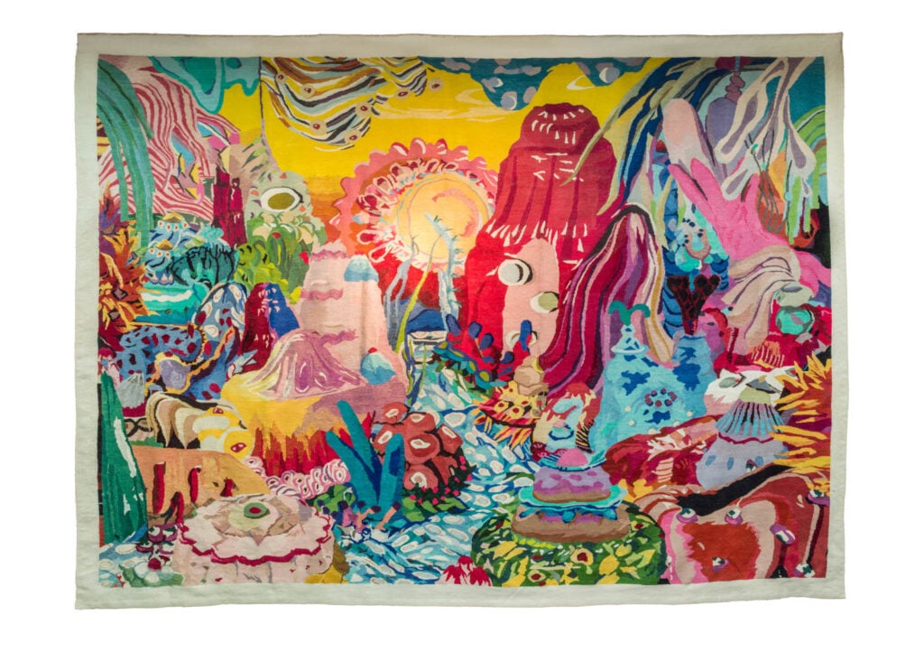 A colorful tapestry featuring an abstract, whimsical landscape with vibrant hills, plants, and sun-like shapes in various bright hues.