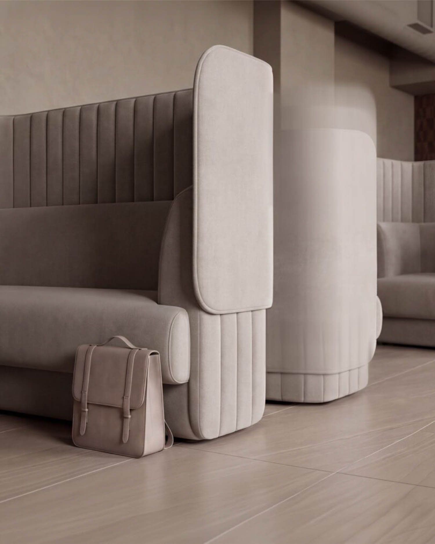 A beige upholstered booth with high back and side panels sits on a wooden floor. A matching beige satchel rests on the floor beside the booth.