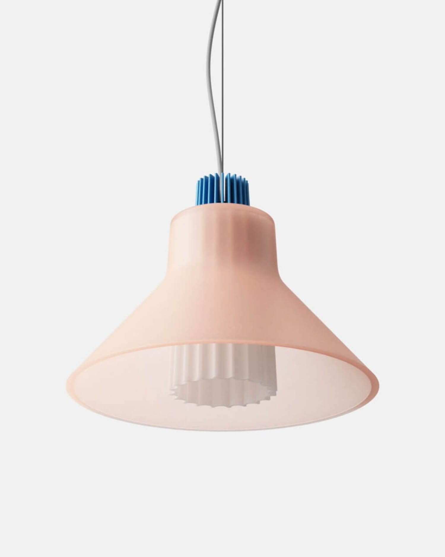 A pink pendant light with a wide conical shade, white ribbed inner diffuser, and blue detail at the top, suspended by a cord against a plain background.