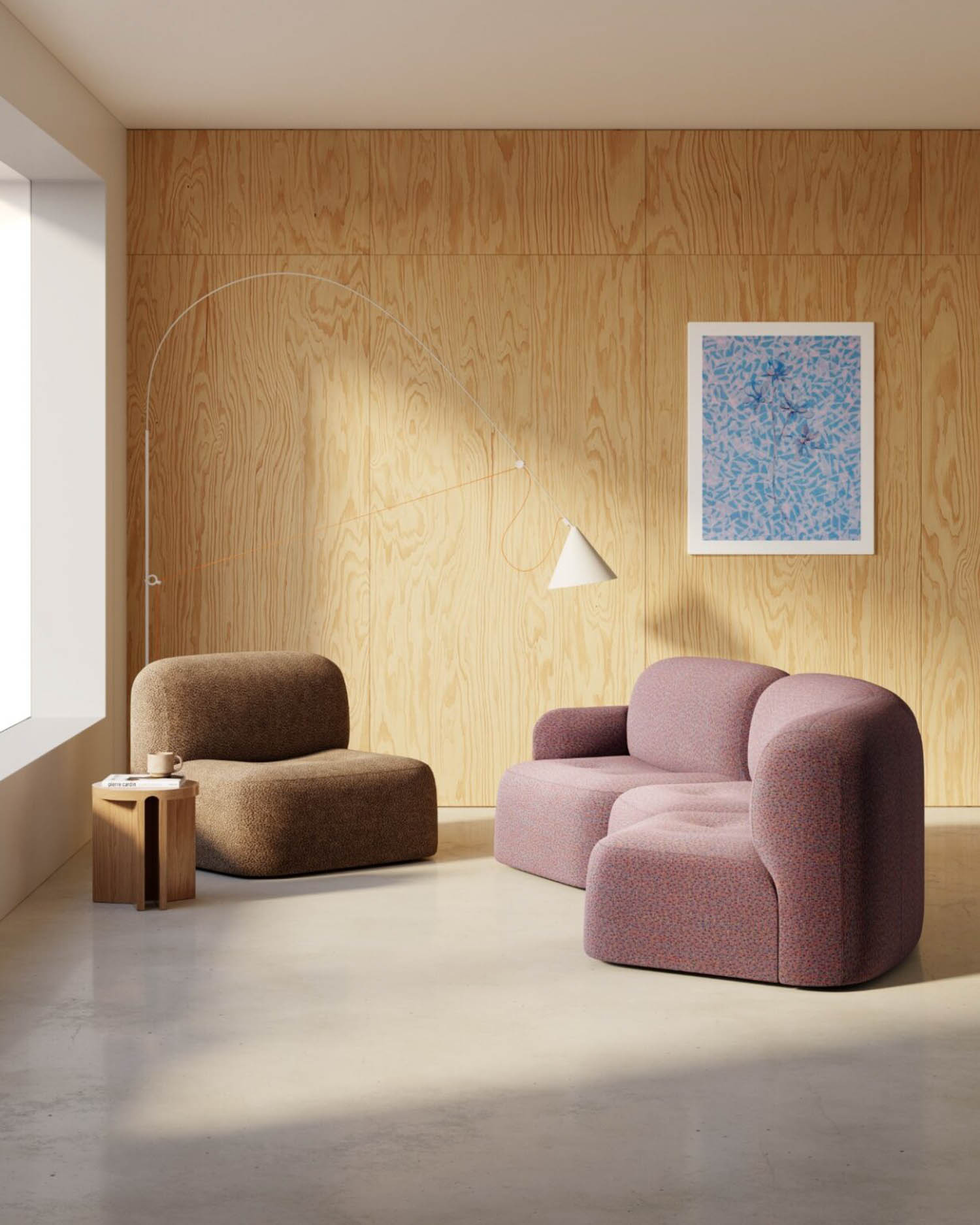 A modern living room with light wood panel walls, a brown armchair, a mauve curved sofa, a small wooden side table, an arched floor lamp, and an abstract blue artwork on the wall.
