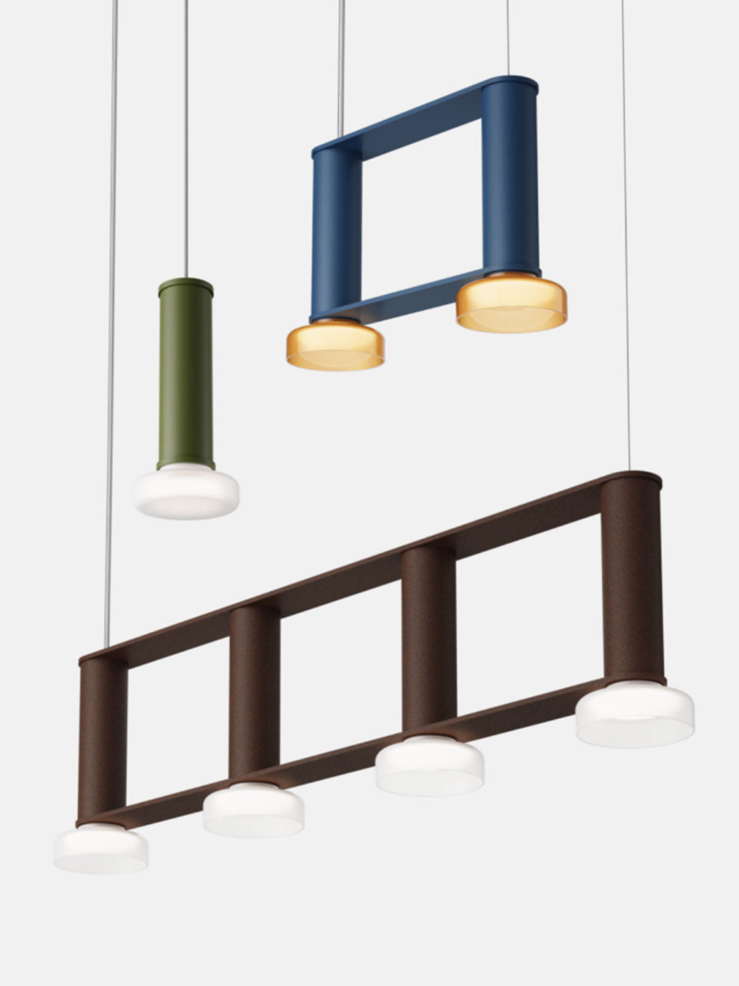 Three modern pendant lights in geometric shapes and different colors—green, blue, and brown—each with integrated white circular light diffusers.