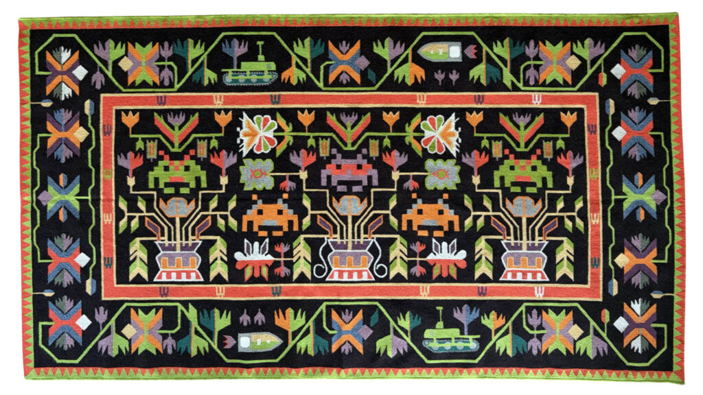 Rectangular woven rug with a black background, featuring colorful geometric floral and vase patterns in red, green, orange, purple, yellow, and blue, bordered by repeating motifs.