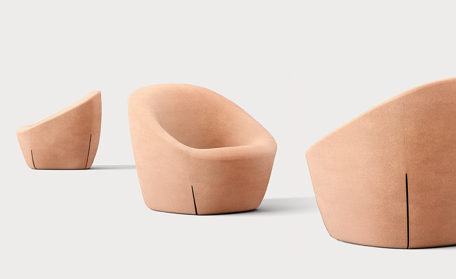 Three modern peach-colored armchairs with curved backs and smooth upholstery are arranged on a plain light background.