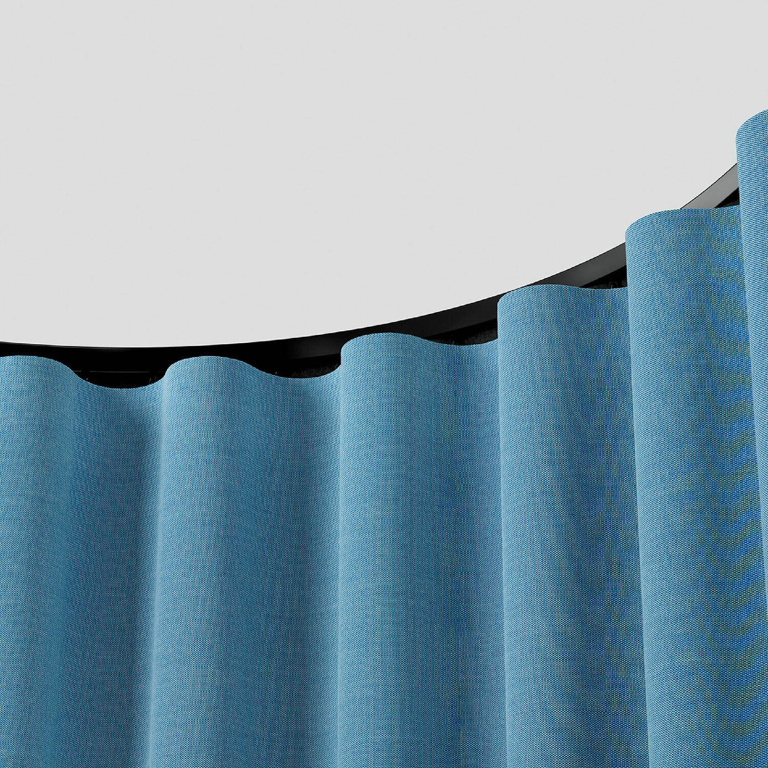 A close-up of a blue fabric curtain hanging in smooth, even waves beneath a curved black curtain rod against a plain white background.