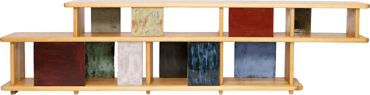 A wooden shelf unit with two tiers, featuring colorful square panels in various colors and finishes as vertical dividers.