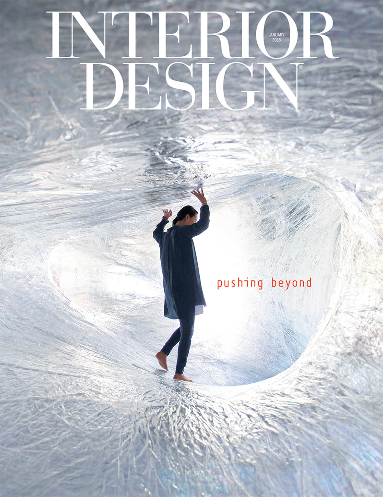 Person standing barefoot inside a silvery, translucent tunnel. The words “INTERIOR DESIGN” and “pushing beyond” are on the image.