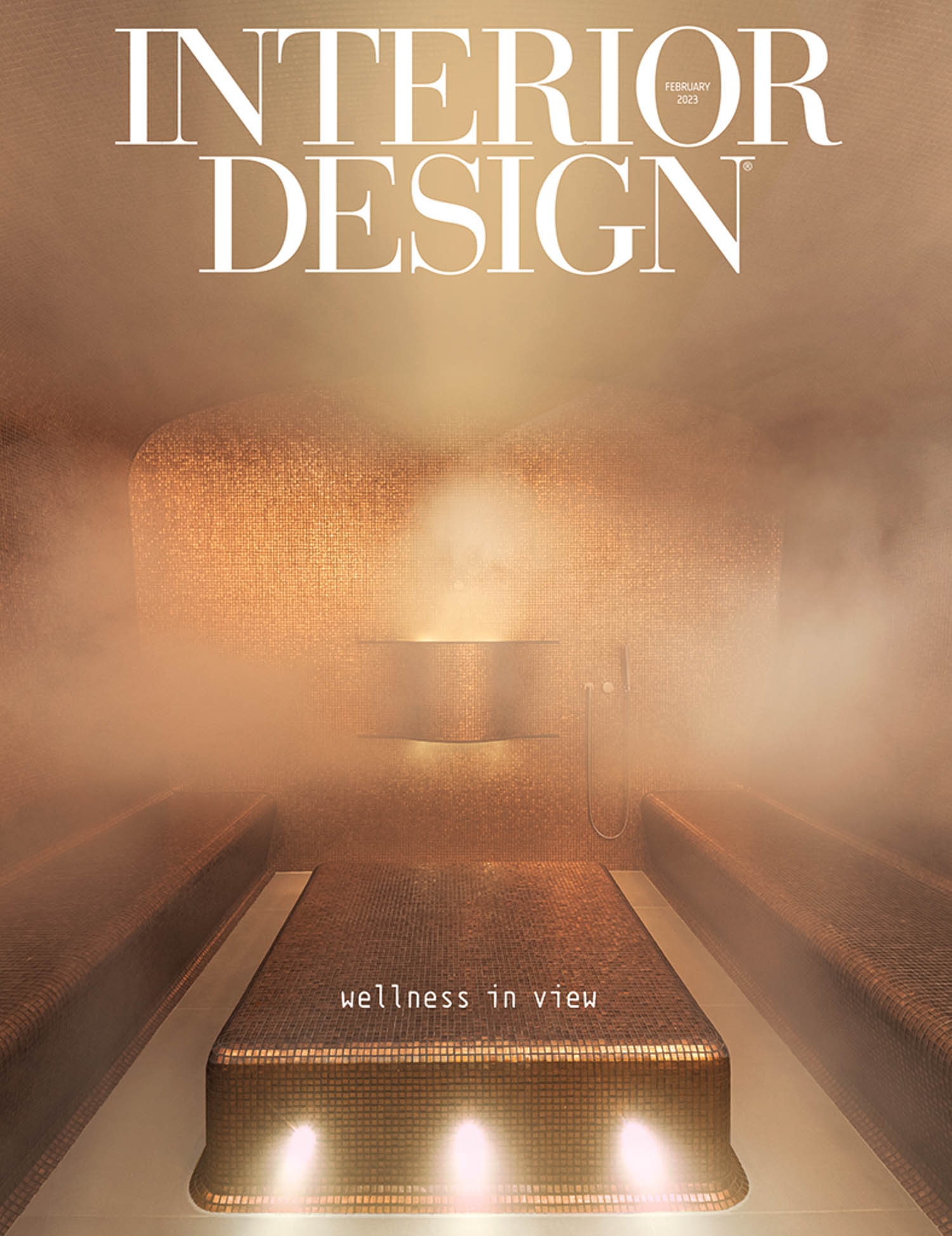 A misty, gold-toned spa room with a tiled heated bench, wall niche, and ceiling lights, featured on the February 2023 cover of Interior Design magazine.