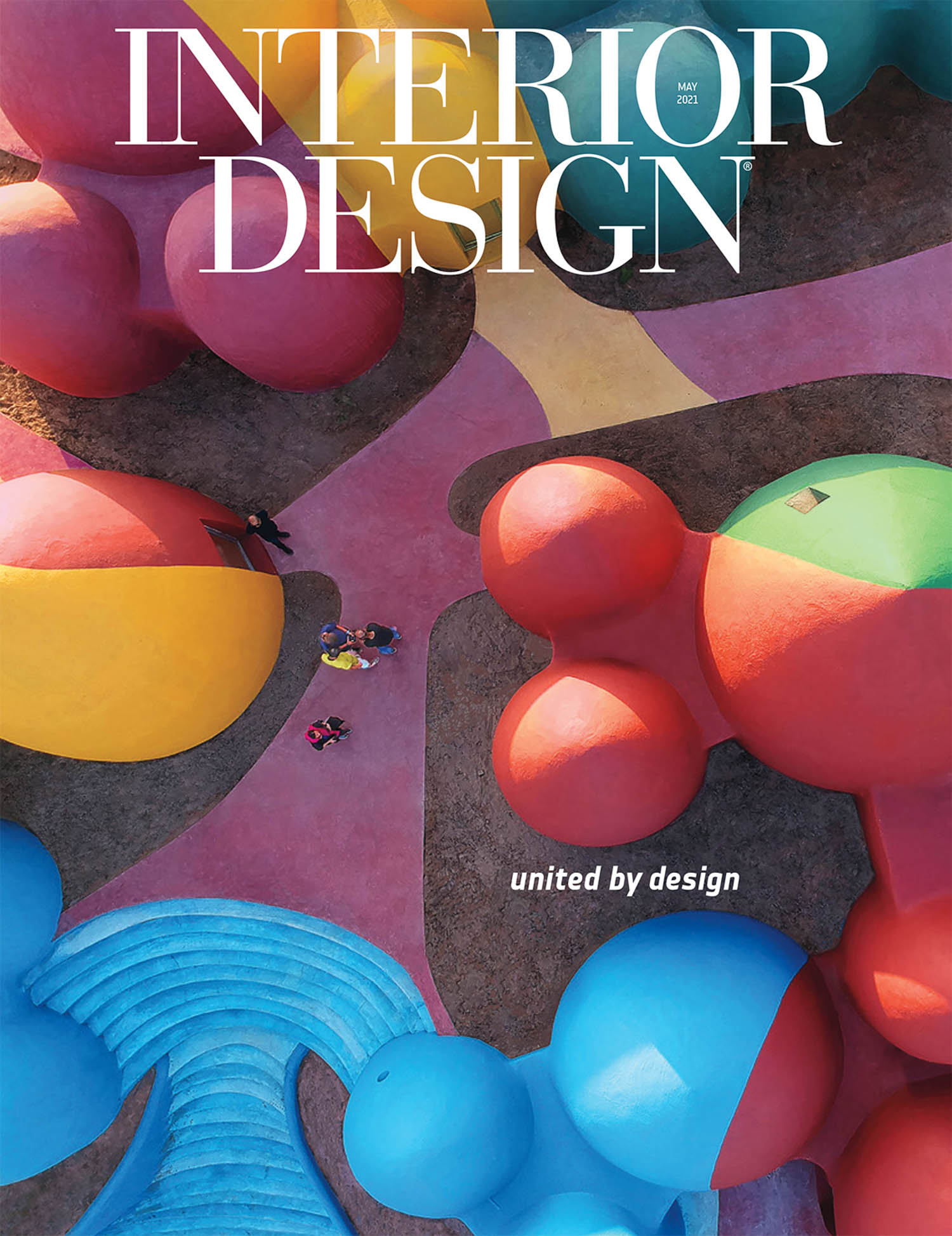 Aerial view of colorful, abstract outdoor structures with people walking, featured on the cover of Interior Design magazine, May 2023 issue.