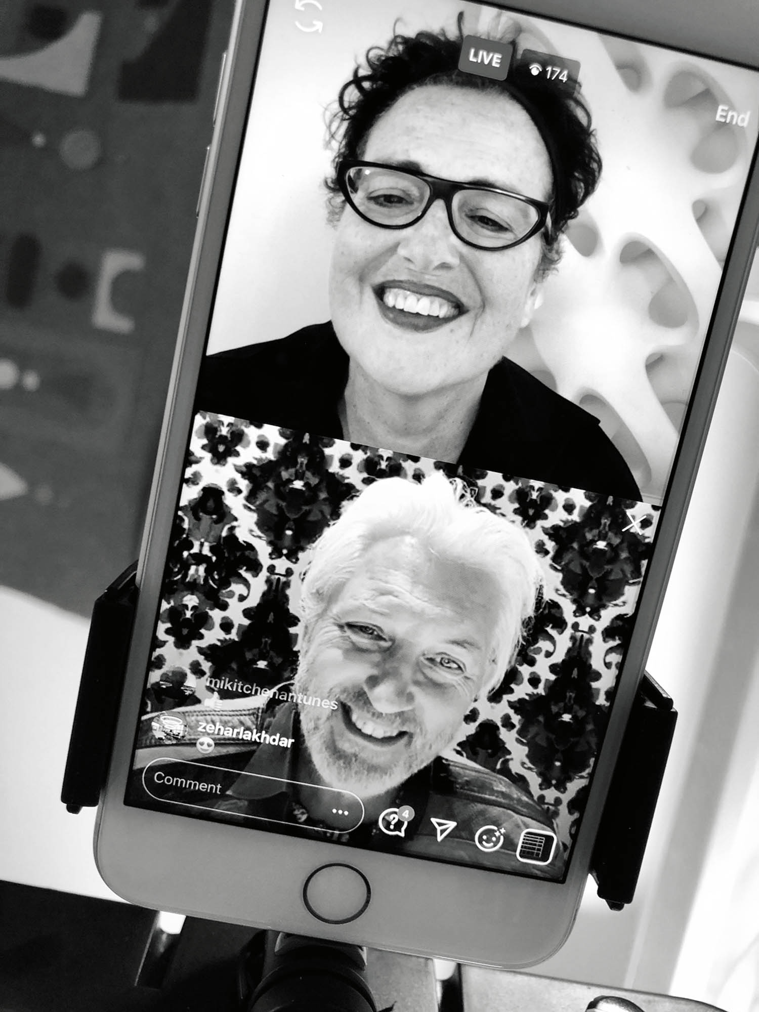 A smartphone displays a live video call between a smiling woman and man, each visible in separate frames, with viewer count and comments on screen.