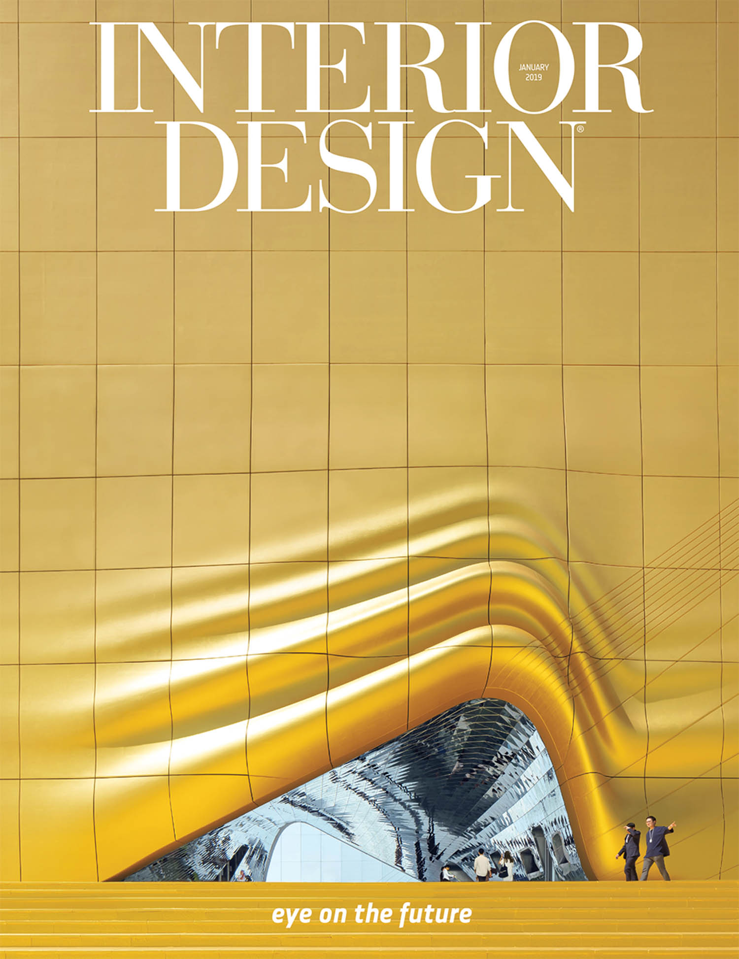 Cover of Interior Design magazine featuring a modern gold building facade with an arched entrance; two people walk outside. Text reads “eye on the future.”.