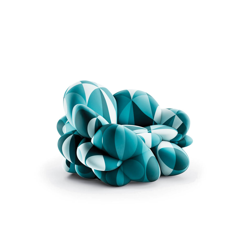 A modern chair with a rounded, geometric design in shades of teal and white, resembling clustered, inflated shapes.
