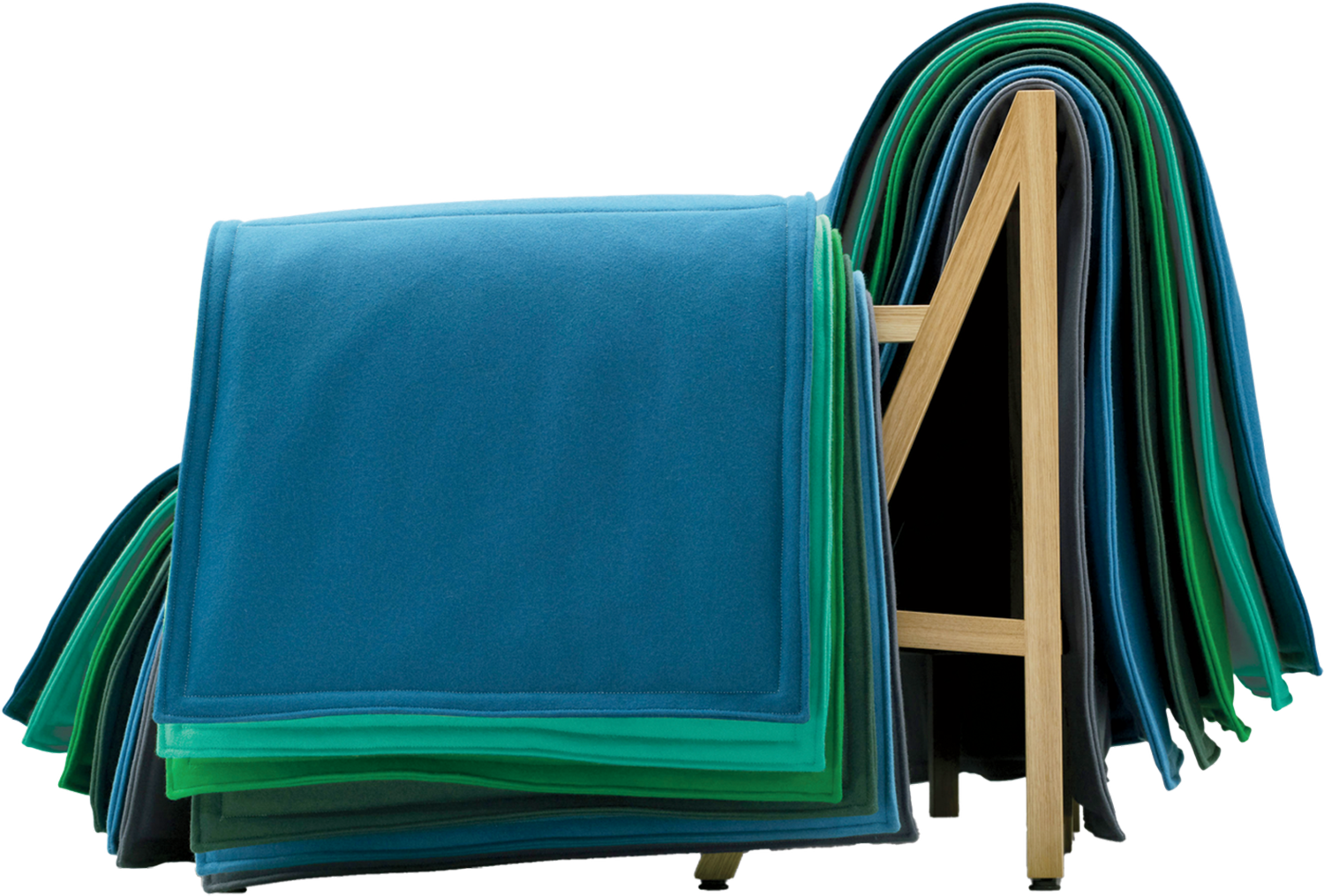 Stacked blue and green blankets draped over a light wooden rack, arranged in an overlapping pattern on a plain background.