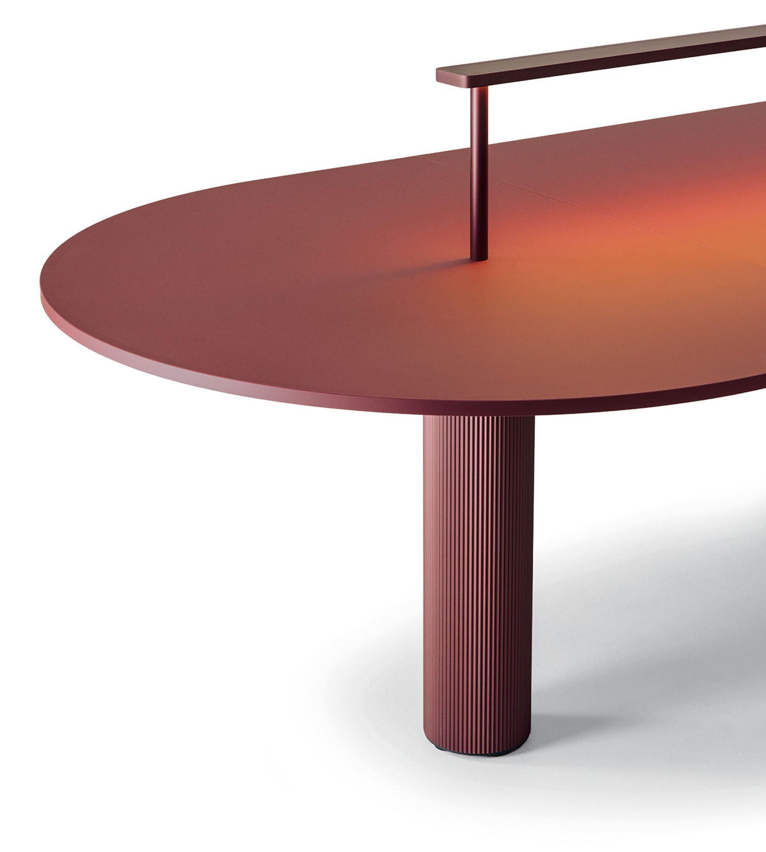 Modern red oval table with a single ribbed cylindrical leg and a raised horizontal bar on the surface, shown against a white background.