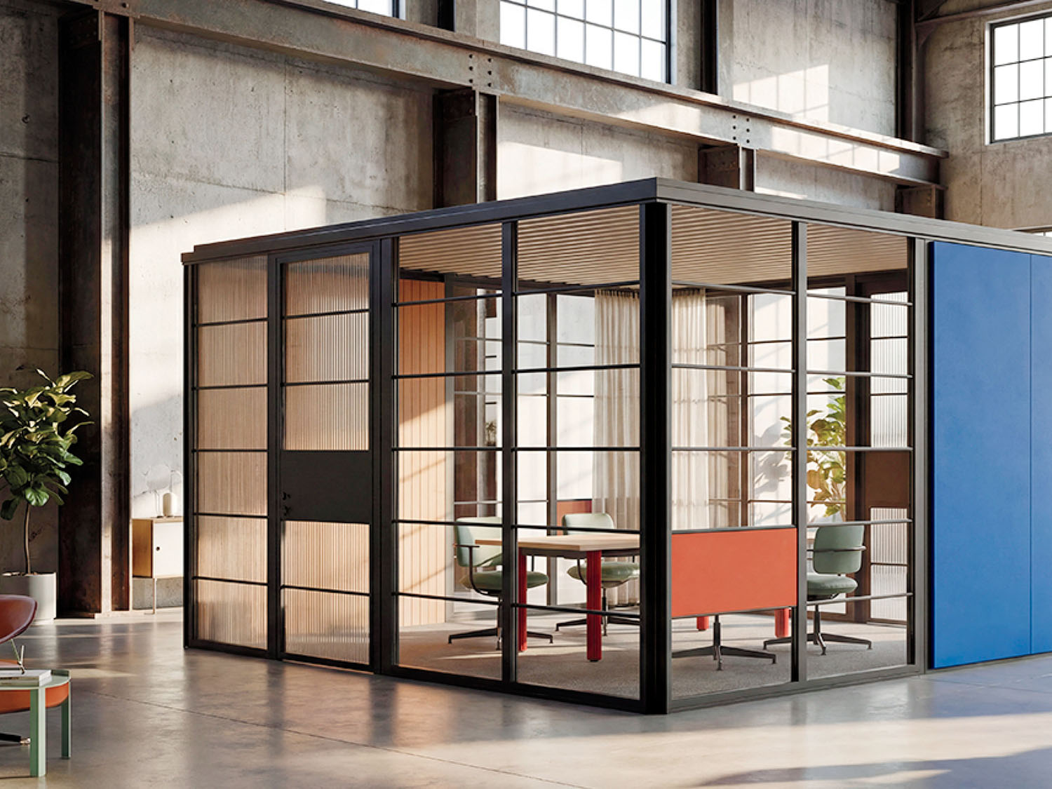 Modern glass-walled meeting room with a table, chairs, and natural light, located inside a spacious industrial-style office.