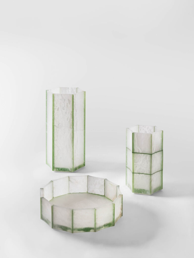 Two hexagonal translucent vases and a shallow hexagonal bowl with green edges.