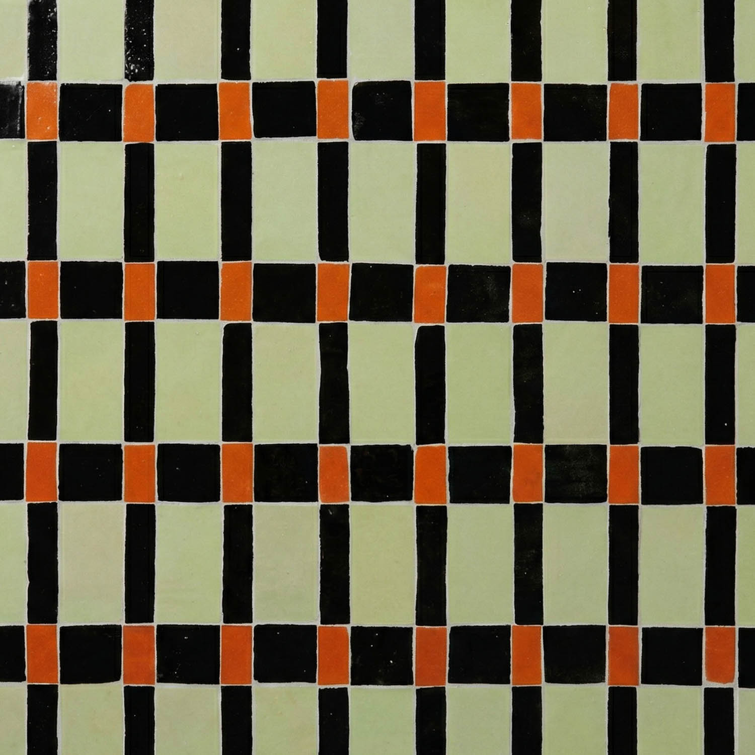 Pattern of square tiles featuring a grid of black, red, and beige colors arranged in a repeating geometric design.