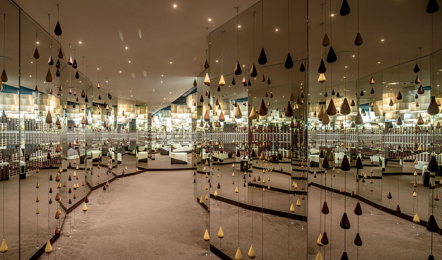 Interior room featuring mirrored walls and hanging teardrop-shaped ornaments.